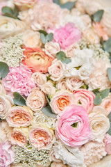 Obraz na płótnie Canvas Closeup beautiful bouquet of mixed flowers. Work of the florist at a flower shop. Delivery fresh cut flower. European floral shop.
