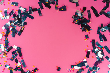 Silver sparkles tinsel on a pink background