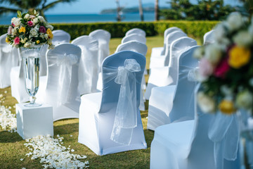 Wedding ceremony. Arch,Chair decorated with flowers on the lawn.