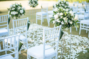 Wedding ceremony. Arch,Chair decorated with flowers on the lawn.