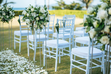 Wedding ceremony. Arch,Chair decorated with flowers on the lawn.