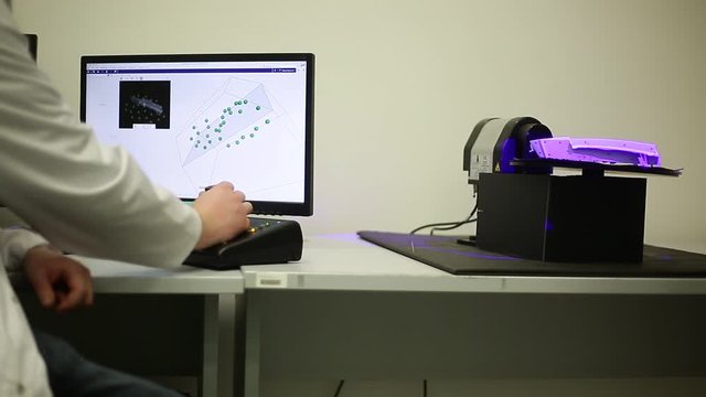 Quality engineer scanning some moldings by professional optical 3D scanner with a turntable, metrology concept
