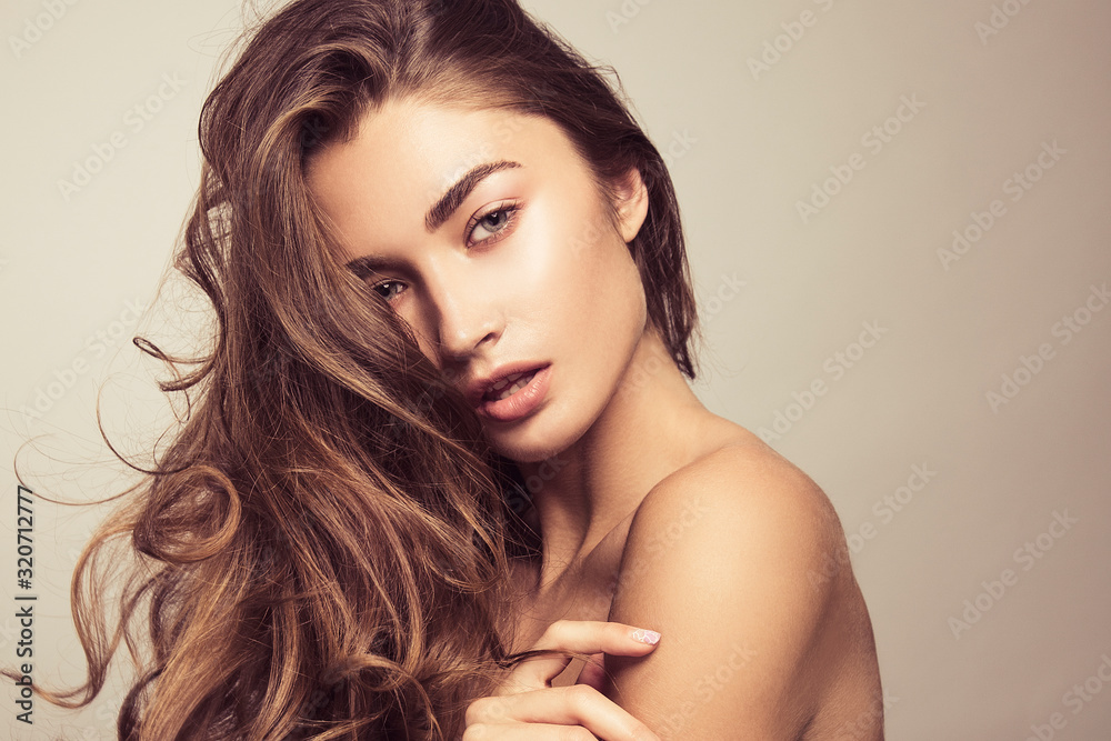 Wall mural portrait of a beautiful girl with natural makeup. beauty style shot. clean skin and hair. close up.