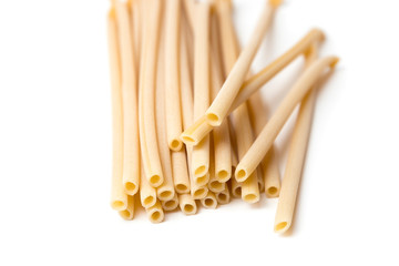 beautiful fresh and raw wholegrain bucatini ,thick, corkscrew shaped pasta on wood board. shallow DOF