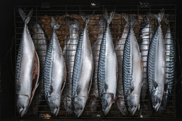 Fototapeta premium raw grilled fish for smoking. Cooking on the nature