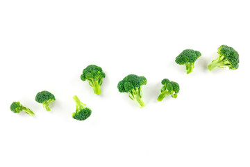 Broccoli florets, overhead shot on a white background with copy space
