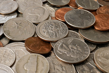 American money. Large pile of coins of American cents of different denominations. Financial background. Selective focus.