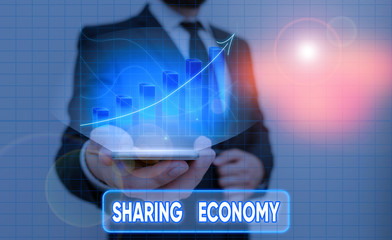 Conceptual hand writing showing Sharing Economy. Concept meaning collaborative consumption or peer...