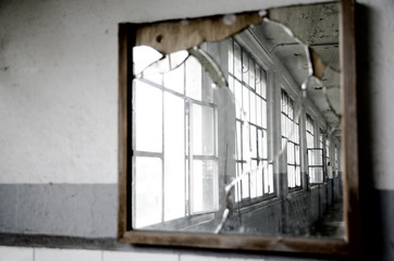 Fototapeta na wymiar Windows Reflected in a Broken Mirror.