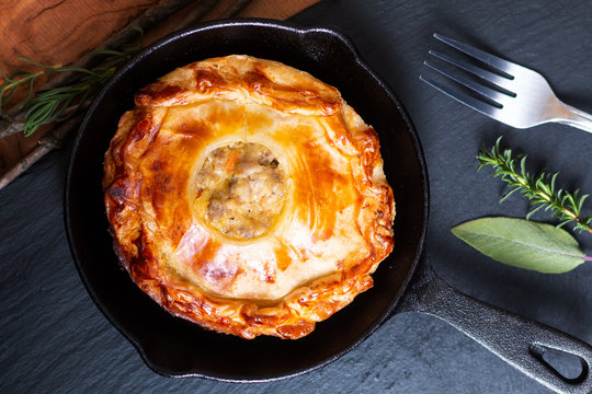 Food Concept Homemade Golden Meat Puff Pastry Pie In Skillet Iron Cast On Black Slate Board With Copy Space