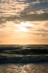 Fototapeta premium Beautiful sunset on tropical beach. The surf pounds the shore. Karon beach, Phuket, Thailand