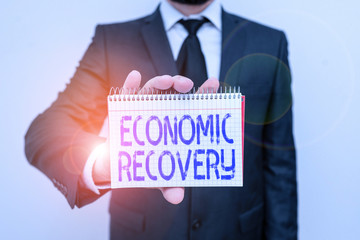 Handwriting text writing Economic Recovery. Conceptual photo rise of business activity signaling...