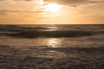 Obraz premium Beautiful sunset on tropical beach. The surf pounds the shore. Karon beach, Phuket, Thailand