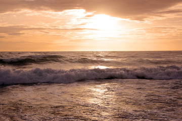 Fototapeta premium Beautiful sunset on tropical beach. The surf pounds the shore. Karon beach, Phuket, Thailand