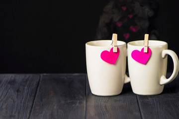 cup with a heart on a clothespin on a dark wooden background