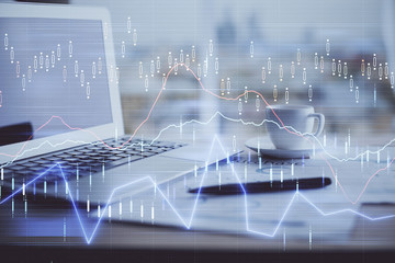 Forex graph hologram on table with computer background. Double exposure. Concept of financial markets.