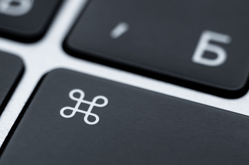 Close-up of a black command key on a keyboard. Function key to control.
