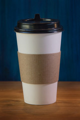 empty cardboard Cup on wooden background