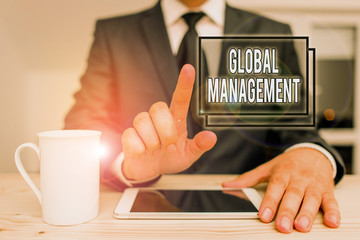 Text sign showing Global Management. Business photo text way an organization analysis its business internationally Male human wear formal clothes present presentation use hi tech smartphone