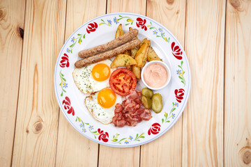 breakfast  - fried eggs, sausage, bacon and vegetables