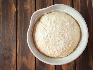 yeast dough on dark wooden surface