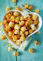 caramelized pop corn in a heart-shaped bowl