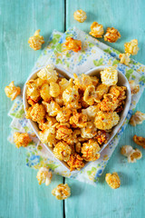 caramelized pop corn in a heart-shaped bowl