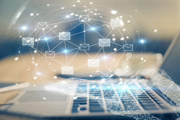 Desktop computer background in office and flying envelops hologram drawing. Multi exposure. Electronic mail concept.