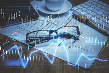 Financial chart hologram with glasses on the table background. Concept of business. Double exposure.
