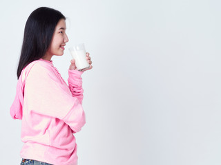Teenage girls holding a glass of milk.