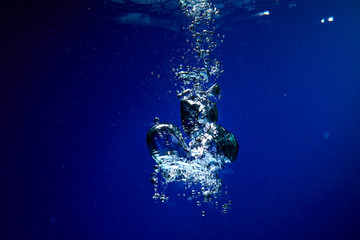 Ice cubes falling into the water