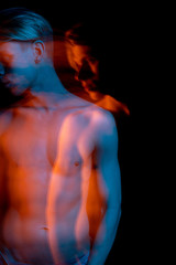 Dreamy naked torso attractive young man long exposure portrait. looking away. indifference and arrogance. abstract conceptual art. complimentary  colors teal orange. representation of subconscious 