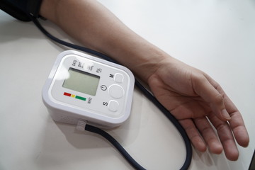 Monitoring blood pressure of patients using upper arm blood pressure monitor in the clinic...