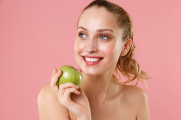 Close up blonde half naked woman 20s perfect skin nude make up hold apple isolated on pastel pink wall background studio portrait. Skin care healthcare cosmetic procedures concept. Mock up copy space.