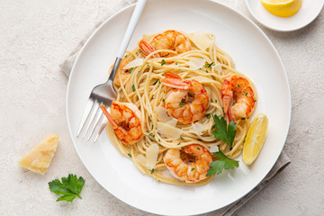lemon and garlic shrims spaghetti pasta on white plate