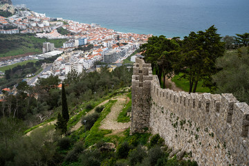 Fototapeta na wymiar Beautiful aerial view of Sesimbra, Portugal - as seen from the castle on the hill, with defensive castle walls