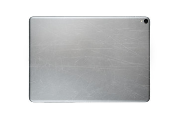 Fototapeta premium Scratched back side of tablet isolated on white background