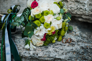 Colorfull bouquet of flowers lying on the rocks