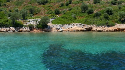 Fototapeta na wymiar Rocky coast overgrown with bushes on the Mediterranean Sea near Marmaris