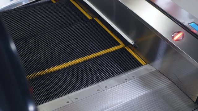Modern escalator stairs moving up