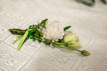 White rose buttonhole on the table