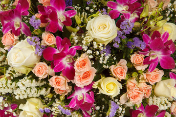 Backdrop of colorful paper roses background in a wedding reception with soft colors. Closeup image of beautiful flowers wall background with amazing red and white roses. Top view