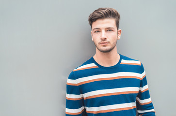 Modern and casual. Handsome young man isolated on gray background