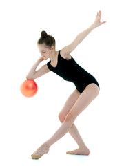 Fototapeta premium little girl is engaged in fitness with a ball.