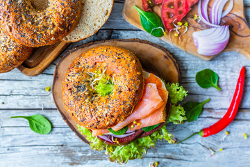 Bagel with salmon and fresh vegetables.
