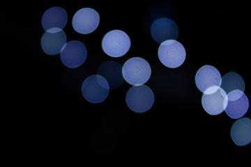 Abstract blurry circles on a black background.
