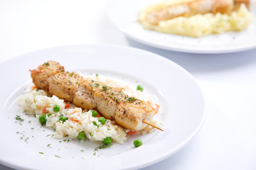 chicken kebab with rice and vegetables on the white background