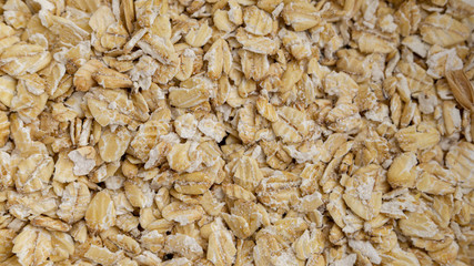 Oatmeal flakes background photo. Macro, full frame