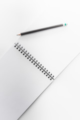 book and pencil opened blank square ctalogue at white design paper background.