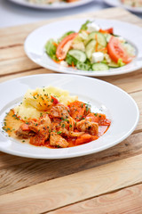 chicken with mashed potatoes and salad on the wooden background